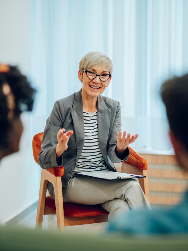 senior-woman-psychiatrist-talking-with-her-patients-during-therapy-session.jpg